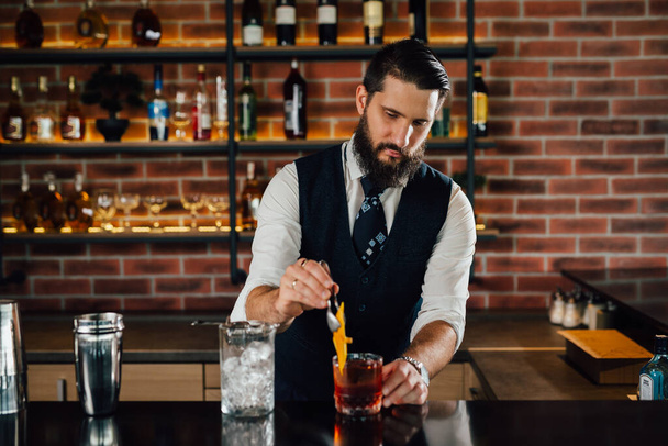 close up of barman preparing cocktail in nightclub - Photo, Image
