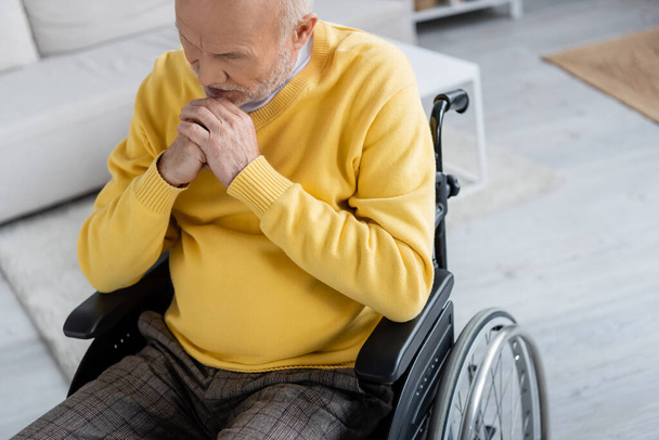 Sad elderly man sitting in wheelchair at home  - Photo, Image