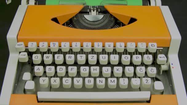 Typewriter stylish orange vintage mechanical typing machine. White keyboard. Camera travel dolly left to right. Close-up. - Imágenes, Vídeo