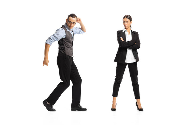 Portrait of office workers, man dancing near woman, employee isolated on white background. Professional growth. Concept of business, office lifestyle, success, ballet, career, expression, ad - Fotó, kép