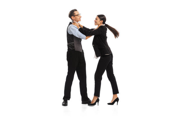 Portrait of man and woman, office managers, employees fighting with each other isolated on white background. Concept of business, office lifestyle, success, ballet, career, expression, ad - Zdjęcie, obraz