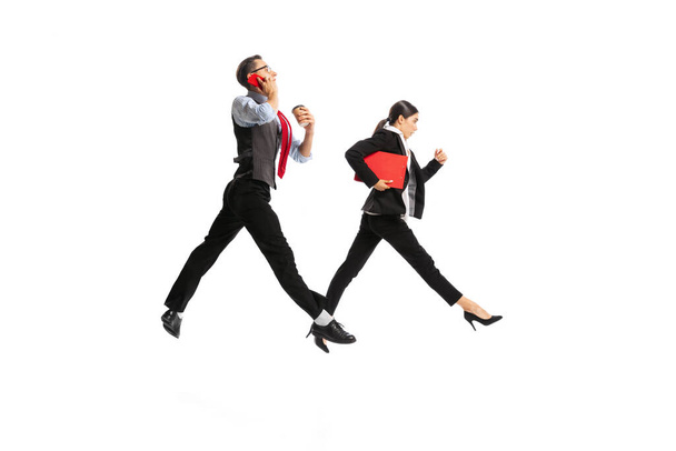 Portrait of man and woman, business people working on their way, posing in action isolated over white background. Concept of business, office lifestyle, success, ballet, career, expression, ad - Foto, afbeelding