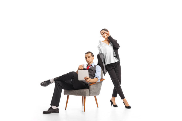 Portrait of man and woman, employees working together isolated on white studio background. Working on business projects. Concept of business, office lifestyle, success, ballet, career, expression, ad - Photo, image