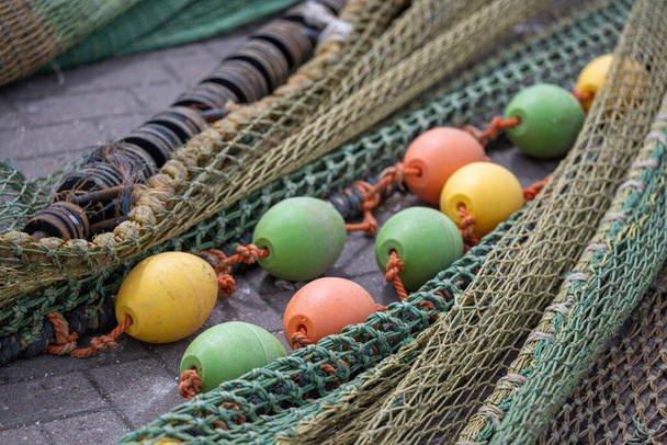Colored nets and ropes on a quay of a Dutch Harbour - Foto, imagen