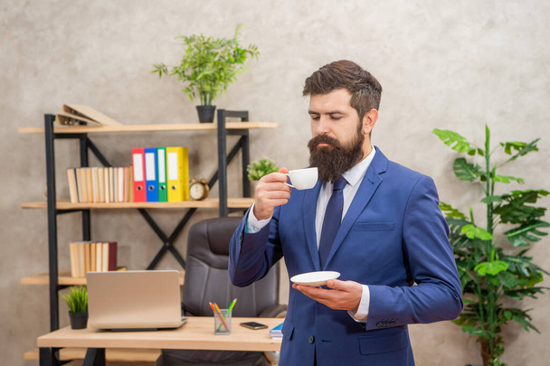 mature entrepreneur in jacket enjoying coffee break at office, guy. - Foto, immagini