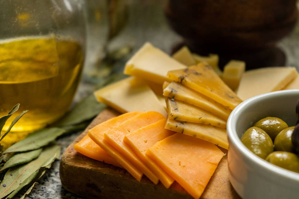 Close-up of cheese board, with cheddar cheese, tybo cheese and flavored cheese - Photo, Image