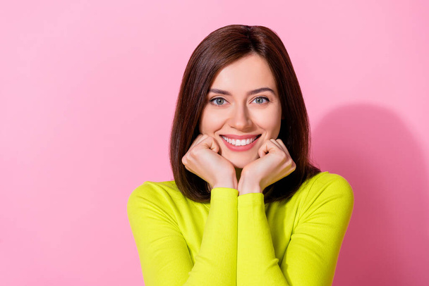Photo of sweet shiny girl dressed lime shirt arms chin cheeks smiling empty space isolated pink color background. - 写真・画像