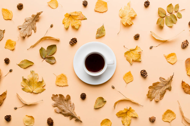 Flat lay composition with colorful Autumn cup of coffee and leaves on a color background. top view. - Photo, Image