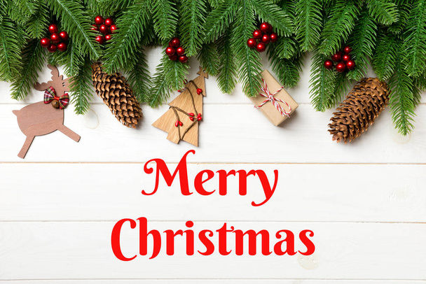 Merry Christmas text. Top view of fir tree and New Year decorations on wooden background. Christmas concept with copy space. - Foto, Imagem