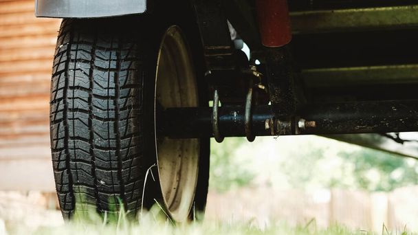 Wheel with a rubber tread from a car trailer. - Zdjęcie, obraz