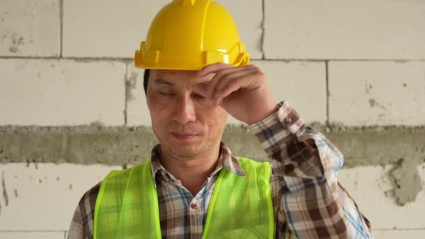 Portrait of asian man industrial worker or Contractor on construction site. Asian Business People in Safety Wear. Man industrial worker looking at camera wearing high vest and hard hat helmet. - Filmagem, Vídeo