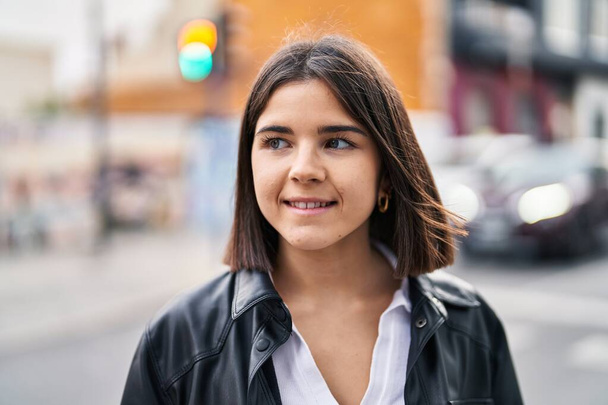 Young beautiful hispanic woman smiling confident looking to the side at street - Fotoğraf, Görsel