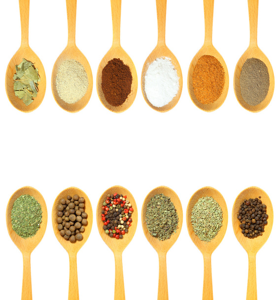 Collection of 12 spices on a wooden spoon. isolated on a white b - Фото, зображення