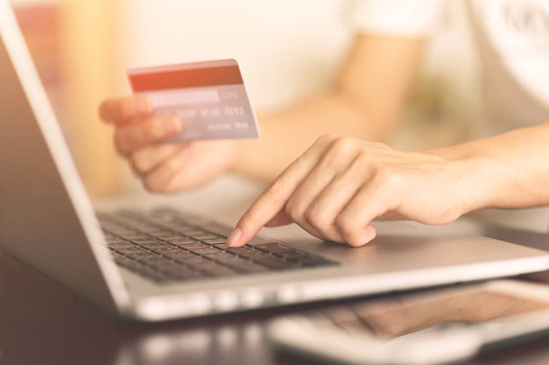 Close up woman hands holding credit card and using laptop shopping purchasing online. e-commerce, internet banking, checking balance, banking service, paying by credit card, making payment - Φωτογραφία, εικόνα