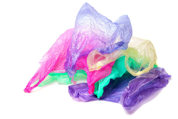 Pile of used multicolored disposable bags with handles isolated on white background - Foto, Imagen