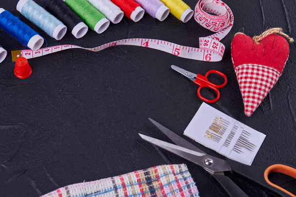 Top view sewing accessories with scissors and threads. Heart shaped needle pillow. - 写真・画像