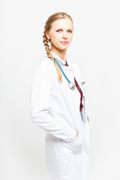 Portrait of an elegant doctor woman in medical gown on white background isolated - 写真・画像