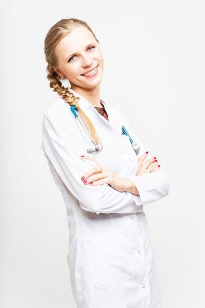 Portrait of an elegant doctor woman in medical gown on white background isolated - Foto, Bild