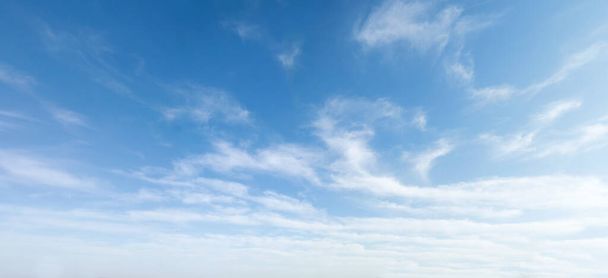 Wide angle photo of sunny and windy weather sky with blue tones. Summer or spring sky with cloudscape. - Foto, afbeelding