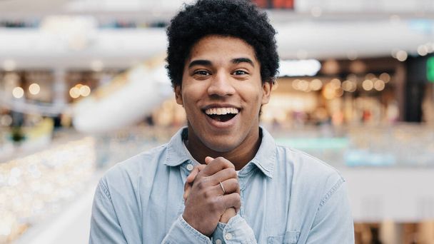 Front view portrait emotions enthusiastic surprised shocked amazed man african american guy teen looking at camera opens mouth and eyes in surprise delight winning victory luck success discount offer - Photo, image