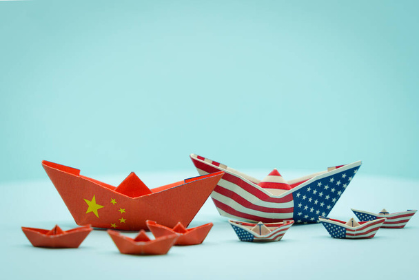 Paper boats with the colors of USA and China facing each other. China and taiwan war conflict concept. USa and china conflict - Photo, image