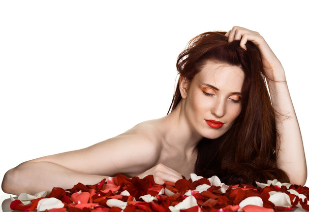 Beautiful woman and rose petals on white background - Zdjęcie, obraz