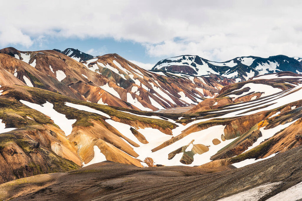 Spectacular scenery of Blahnjukur trail with volcanic mountain and snow covered in Fjallabak nature reserve on Icelandic highlands at Landmannalaugar, Iceland - Photo, image