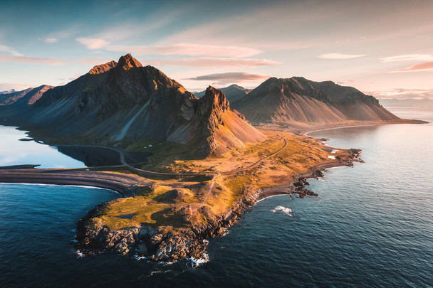 Aerial view of spectacular Mount Eystrahorn in the Krossasnesfjall mountain range and sunlight shine in the morning on coastline in summer at East of Iceland - Foto, Imagen