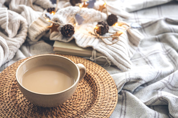 Cozy autumn composition with a large cup of coffee and cute decor details in the bed. - Photo, Image
