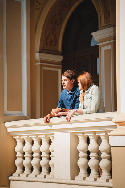 Cute young beautiful hipster couple travelling Europe, standing at the Opera House balcony. - Fotoğraf, Görsel