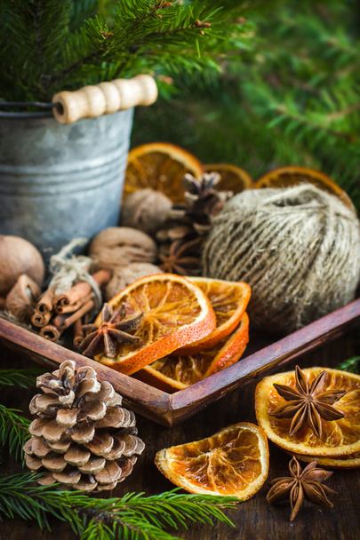 Christmas decoration. Dried oranges, pinecone and nuts. - Photo, Image