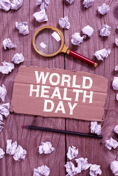 Sign displaying World Health Day, Business idea Global health awareness day celebrated every year Cardboard With New Ideas With Paper Wraps, Pencil And Magnifier Around. - Valokuva, kuva