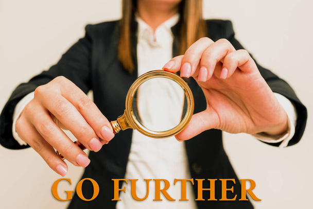 Sign displaying Go Further, Business overview To move to a greater distance or overcome your limitations Woman Having Magnifying Glass To Point Important Information. - Foto, imagen