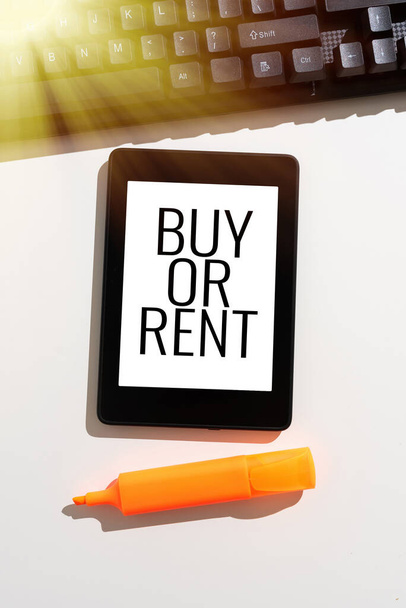 Writing displaying text Buy Or Rent, Business idea Doubt between owning something get it for rented Indecision Important Message Presented On Tablet On Desk With Keyboard And Marker. - Foto, Imagen