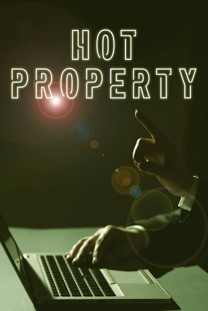 Text sign showing Hot Property, Concept meaning Something which is sought after or is Heavily Demanded Man Typing On Lap Top And Woman Pointing With One Finger On Important News. - Fotografie, Obrázek