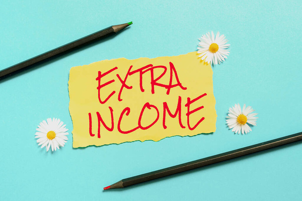 Inspiration showing sign Extra Income, Word Written on Additional fund received or earned from a non regular basis Ripper Piece Of Paper With New Ideas With Flowers And Pencils Around. - Photo, Image