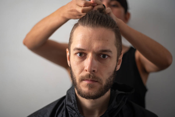 Young White Male with Beard get a Hair Cut by a Peruvian Woman - Fotoğraf, Görsel