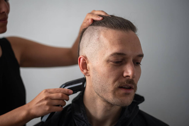 Young White Male with Beard get a Hair Cut by a Peruvian Woman - Photo, Image