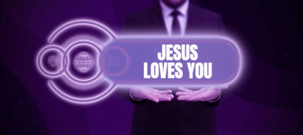 Handwriting text Jesus Loves You, Conceptual photo Believe in the Lord To have faith religious person Businessman in suit holding notepad symbolizing successful teamwork. - Valokuva, kuva