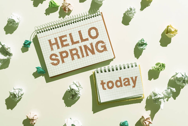 Text caption presenting Hello Spring, Business idea Welcoming the season after the winter Blossoming of flowers Notebooks With Important Messages Surrounded By Paper Wraps. - Photo, image