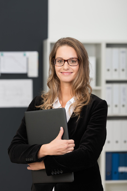 Confident businesswoman clutching file - Photo, Image