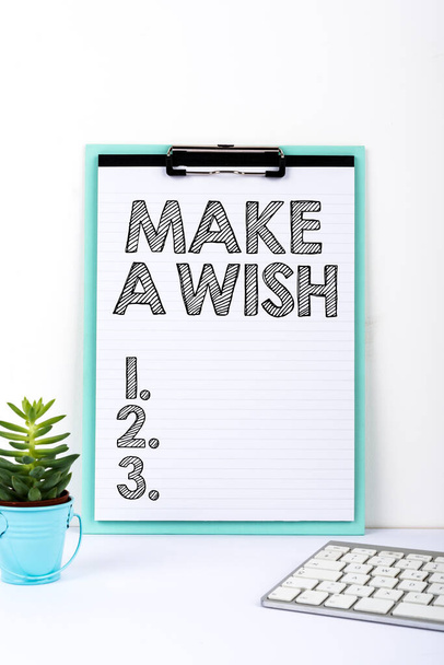 Text sign showing Make A Wish, Internet Concept To have dreams desires about future events Be positive Important Message Presented On Clipboard On Desk With Flower And Keyboard. - Foto, imagen
