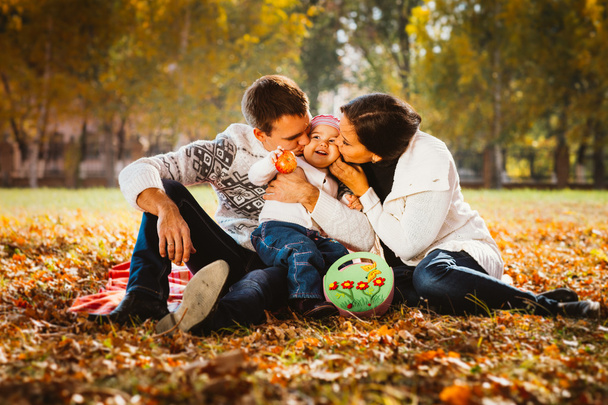 Happy mother, father and daughter in the park - 写真・画像