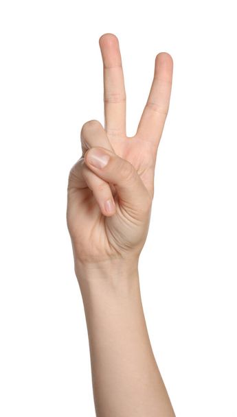 Woman showing peace gesture on white background, closeup of hand - Foto, Bild