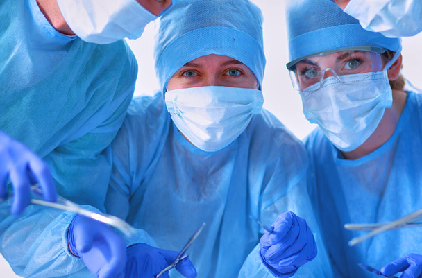 Below view of surgeons holding medical instruments in hands . - Fotografie, Obrázek