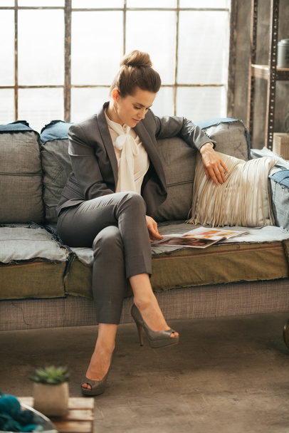 Business woman reading magazine in loft apartment - Zdjęcie, obraz