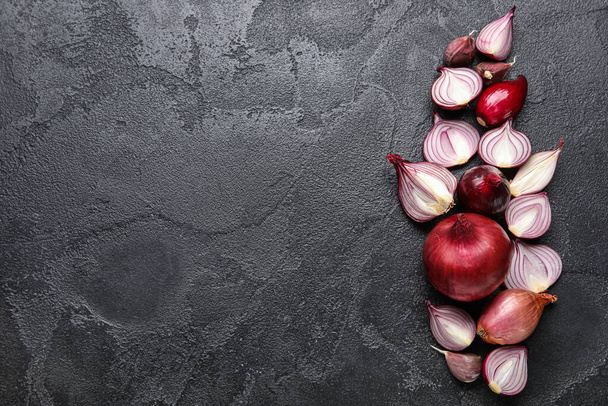 Composition with cut red onion on dark background - Fotó, kép