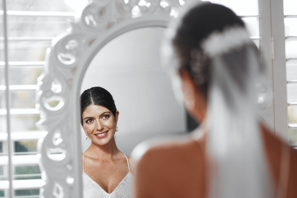 So...the big day has finally arrived. Rearview shot of an attractive young bride looking in the mirror while getting ready for her wedding ceremony - Fotoğraf, Görsel