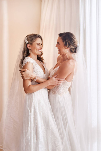 This is finally happening. two attractive young brides holding each other in excitement before their wedding - 写真・画像