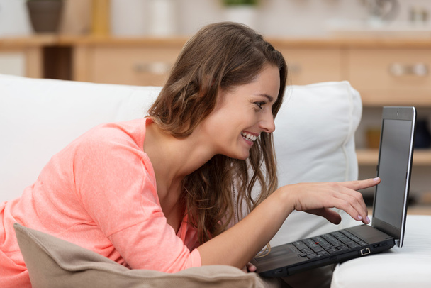 Woman reading information on laptop - Foto, imagen